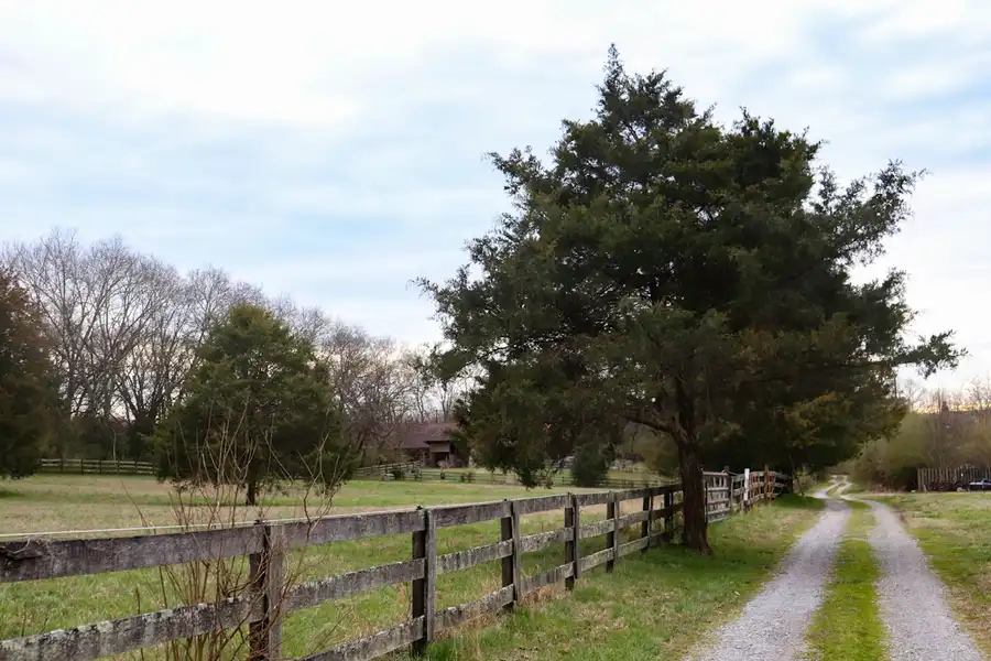 Gravel driveway with fence line on a rural Aubrey TX property